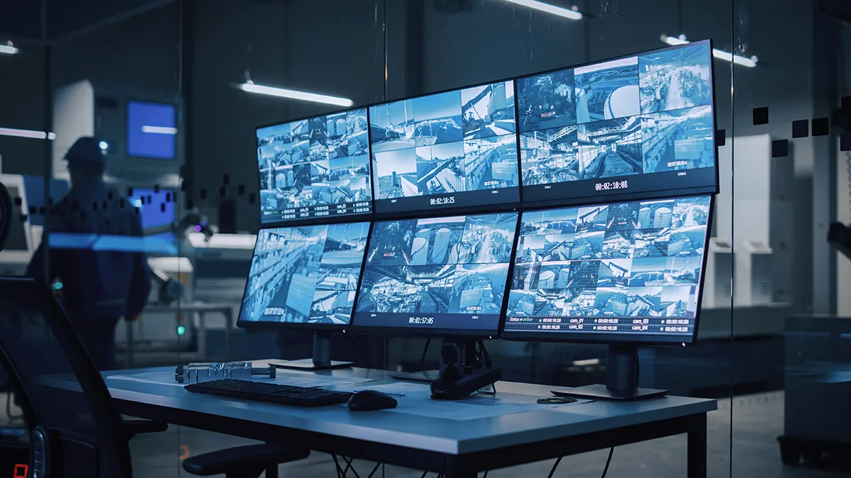 Security camera views displayed on multiple monitors in a control room